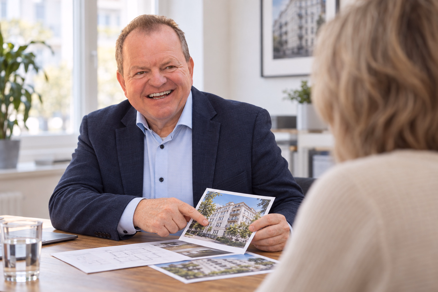 Oliver Preikschat bespricht mit einer Kundin Unterlagen zur Immobilienbewertung vor dem Verkauf.